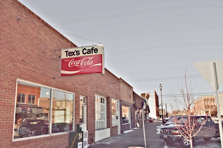 Outside view of brick building of tex's cafe. 