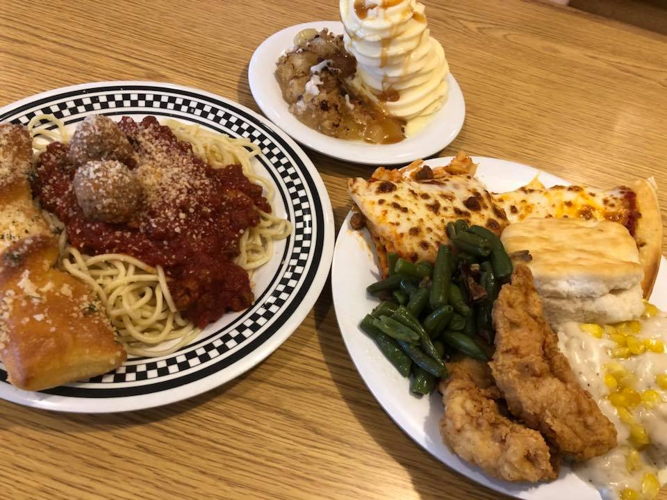 a plate of spaghetti, chicken strips and green beans with a side plate of ice cream with caramel drizzle. 