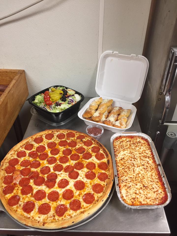 take out order of pepperoni pizza, baked pasta, cheesy bread sticks, and a large salad. 
