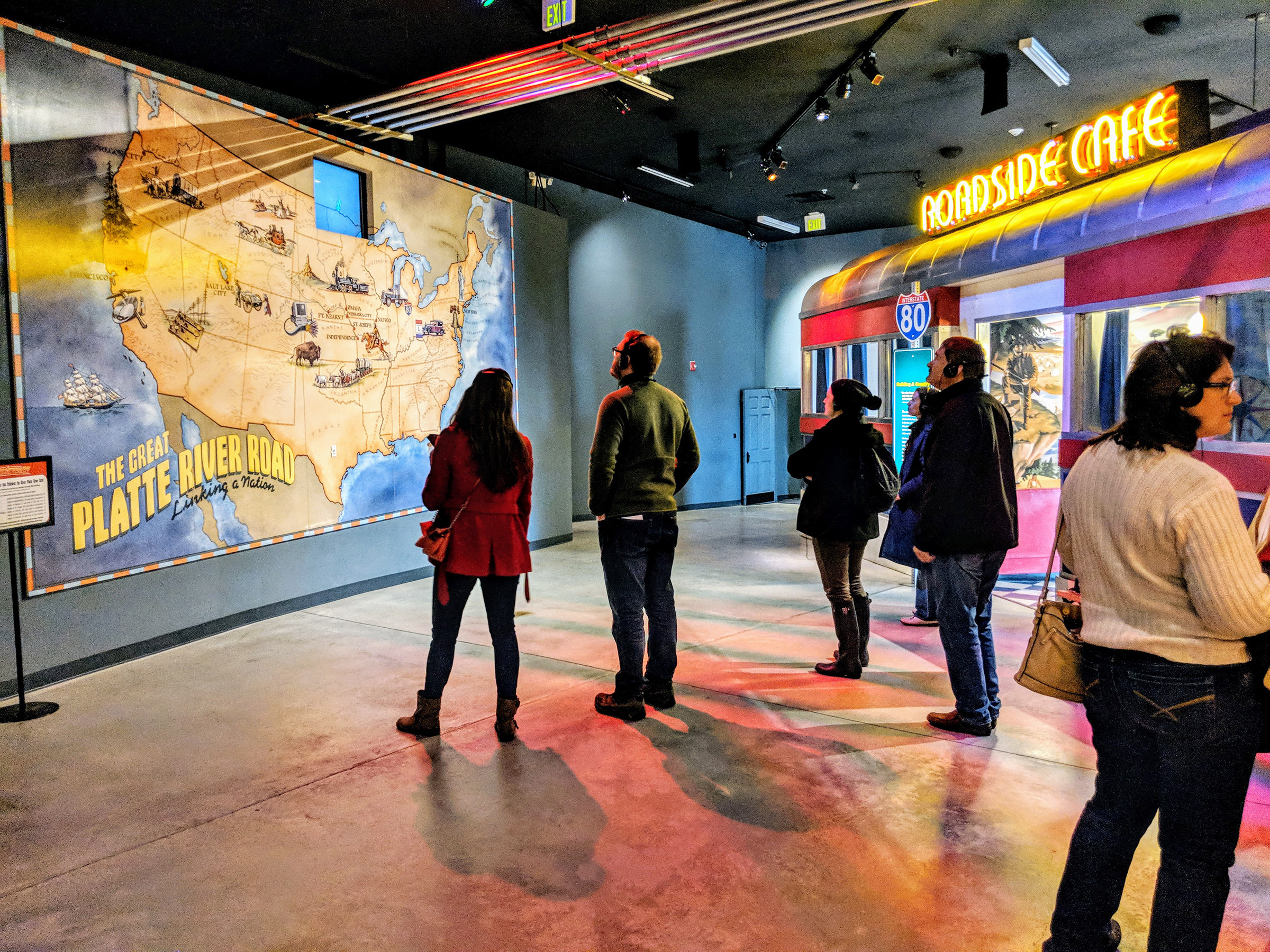 People observing a map of the United States at the Kearney archway.