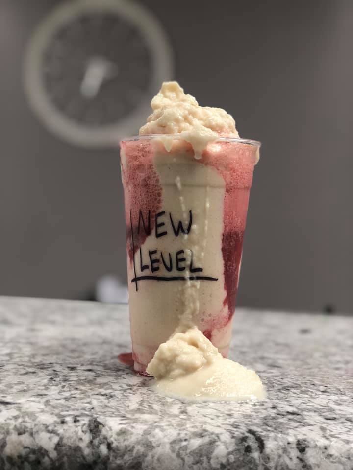 Strawberry and vanilla shake with New Level written on it. 