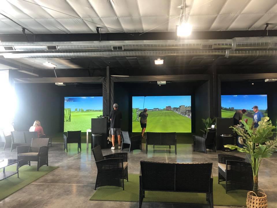 people playing golf indoors 
