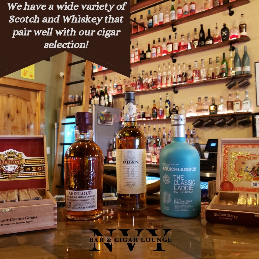bottles of scotch and whiskey on bar top. 