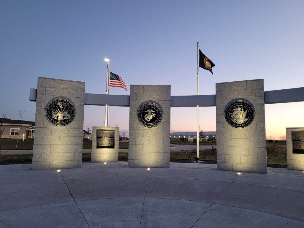 Three service stones with a symbol of an American service branch.