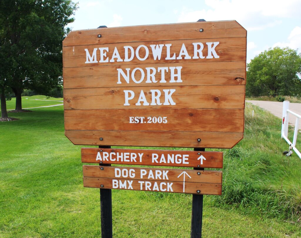 meadowlark north park sign with arrows pointing toward the archery range and park. 