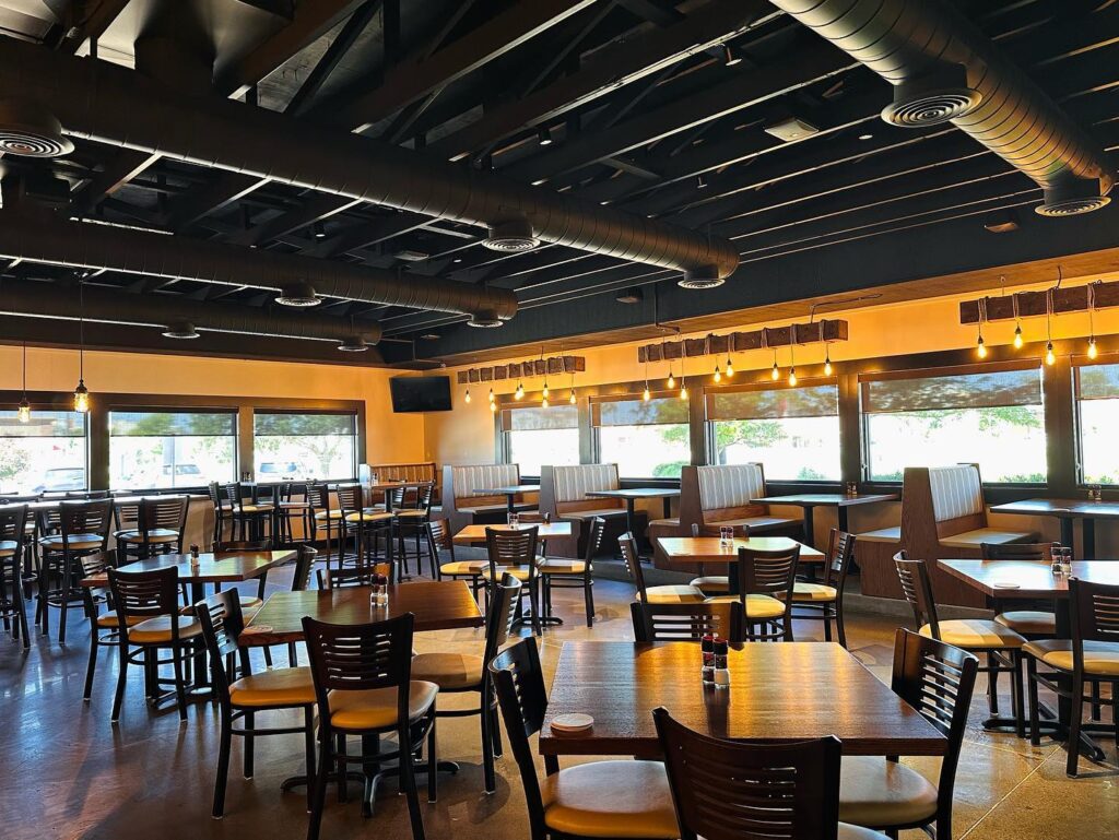 The restaurants modern seating with hanging lights and exposed ceiling. 