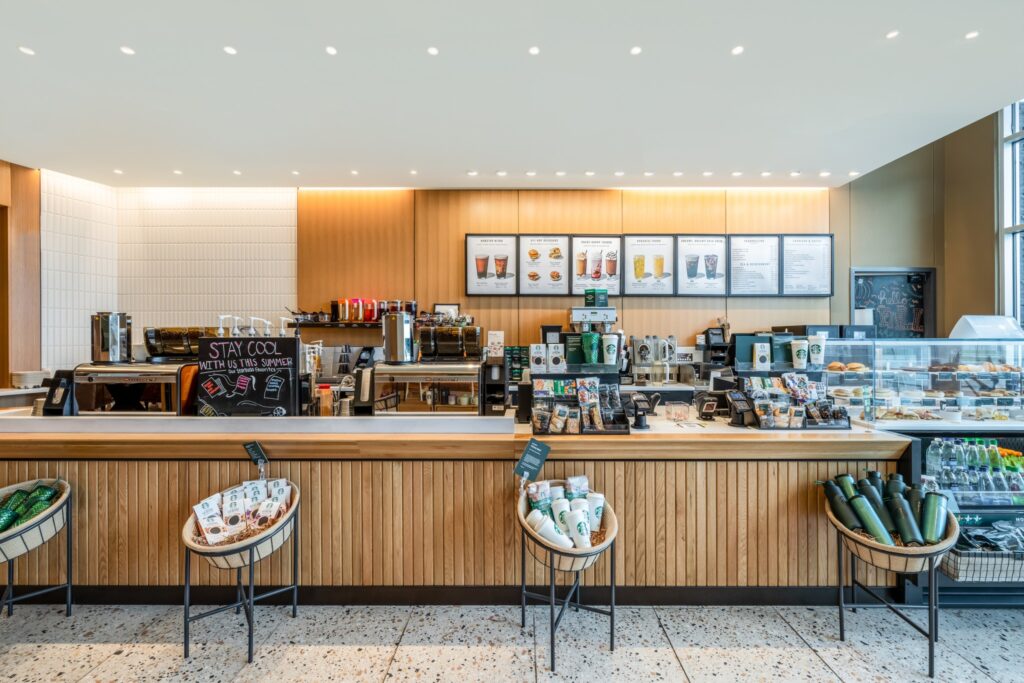 Modern coffee shop look of Starbucks with the counter to order and pastries displayed. 