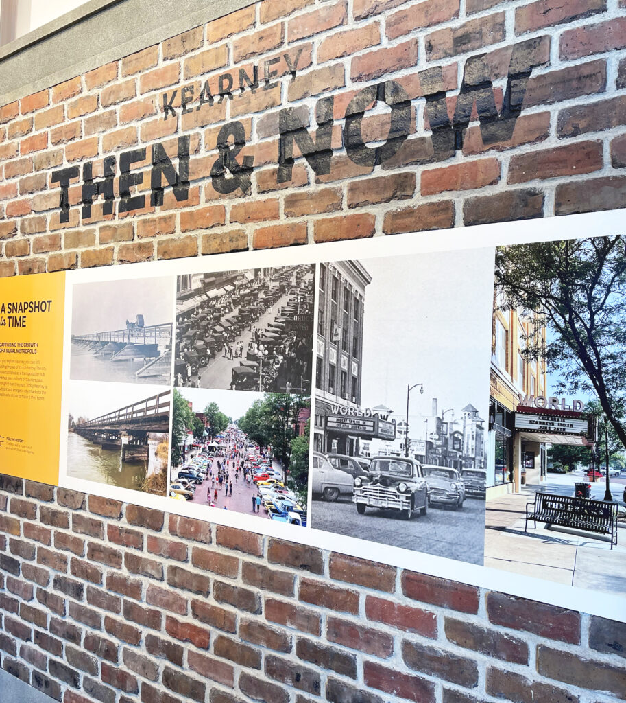 Brick wall displaying Kearney Then & Now with photos of the city through the years 