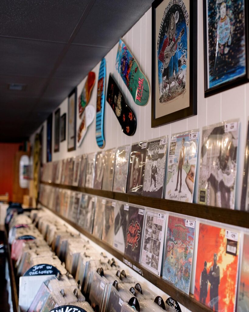 Record Store displaying records on wall and album covers in picture frames. 