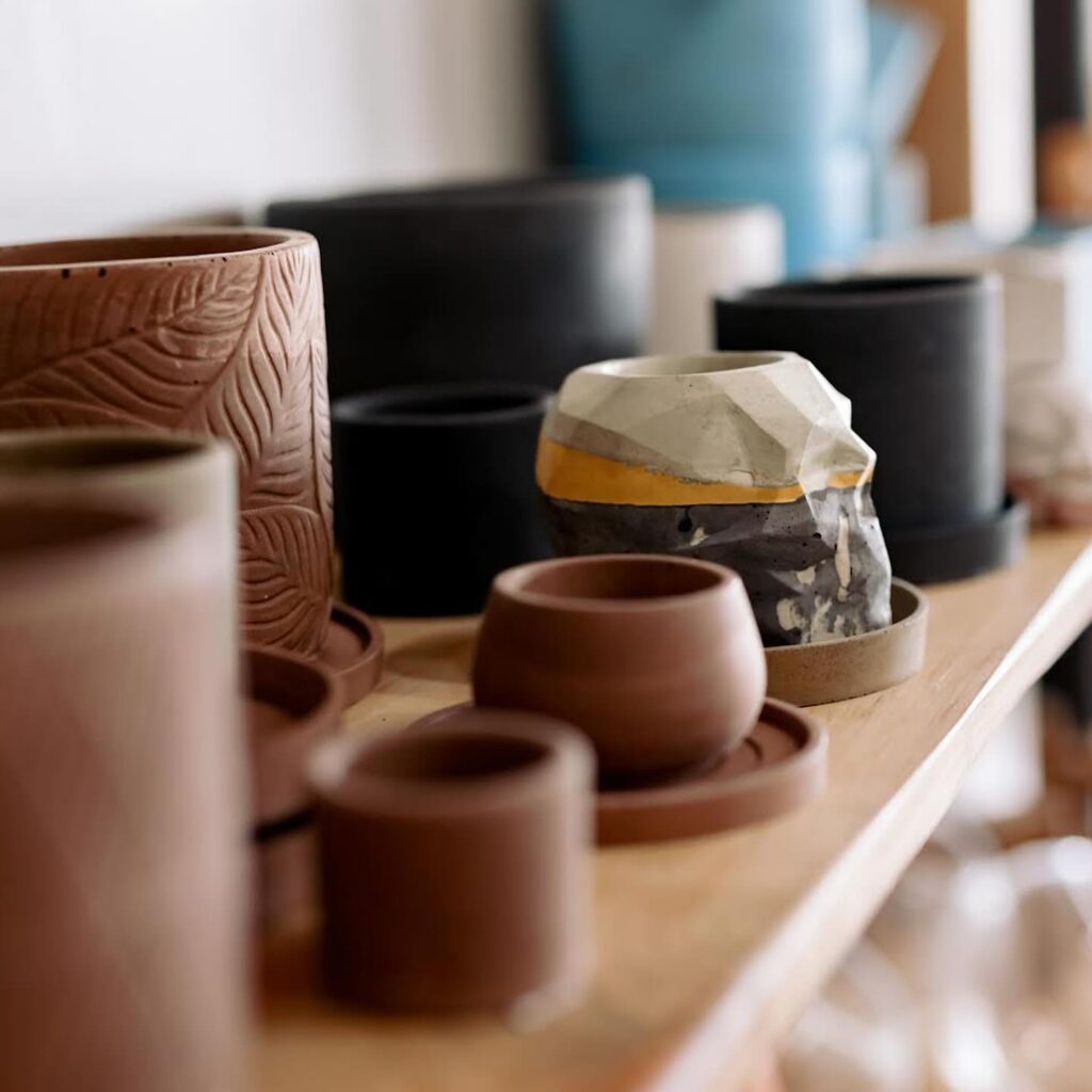 shelf displaying brown clay pots. 