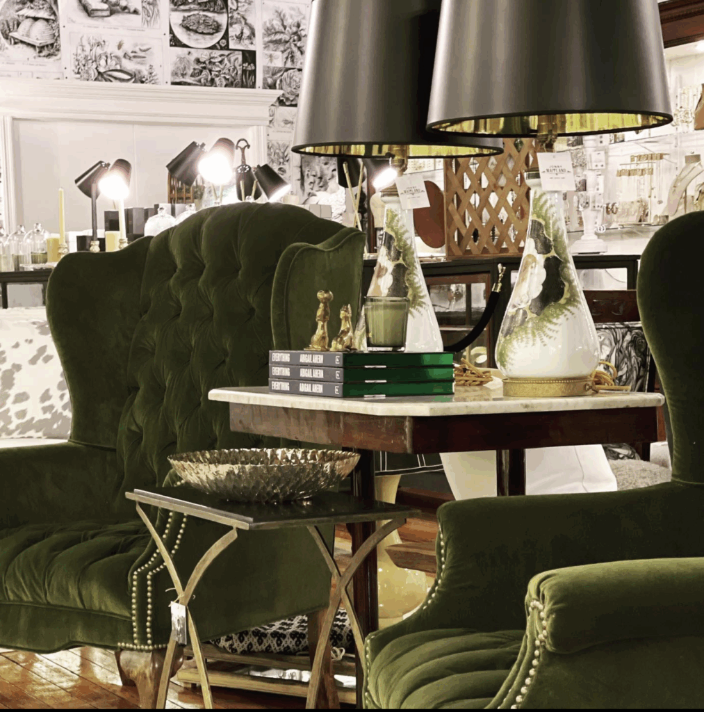 elegant green chairs with table between holding lamps and books on sale. 