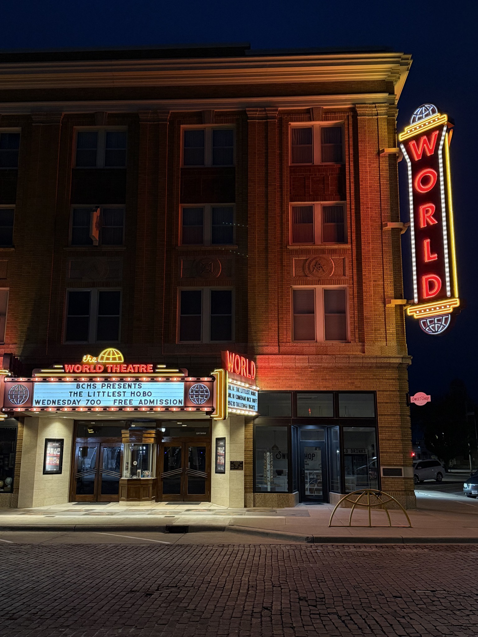 The World Theater with its light up sign at nighttime on the bricks 