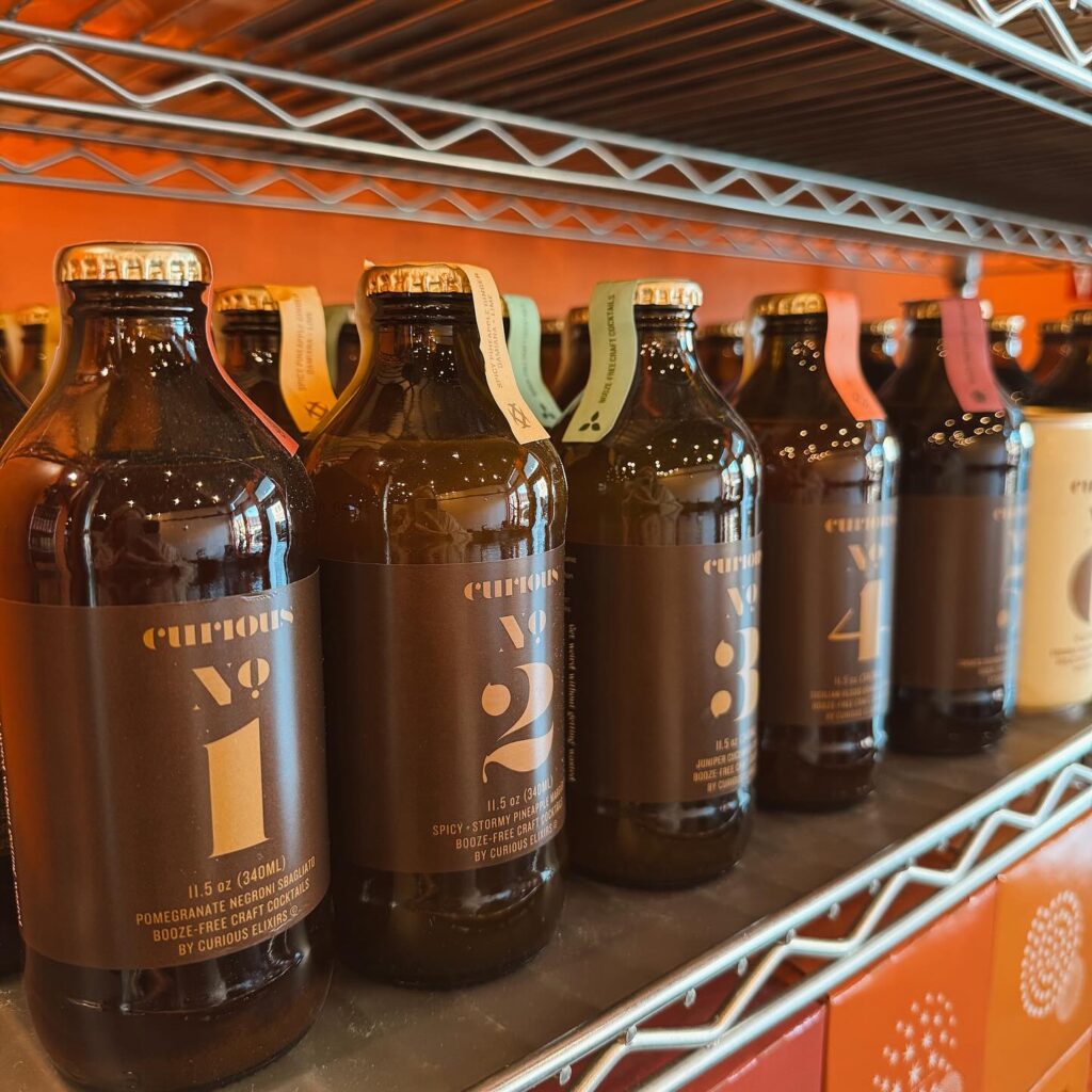 bottles of alcohol on metal wire shelves. 