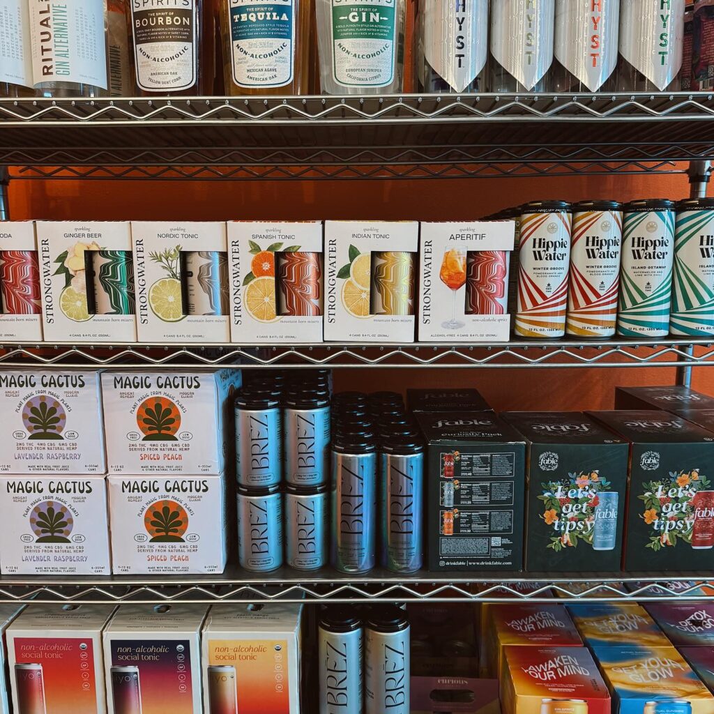 cans of fruit alcoholic beverages on wire shelves. 