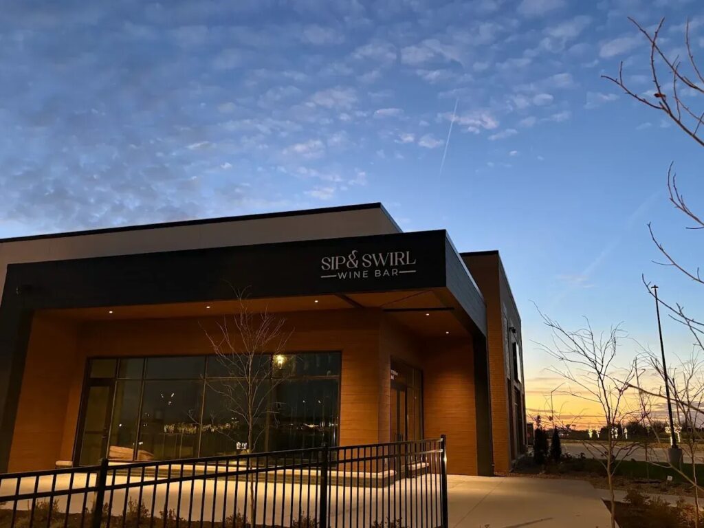 exterior view of Sip and Swirl wine bar at sunset. 