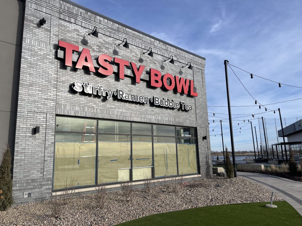 exterior grey brick building of Tasty Bowl. 