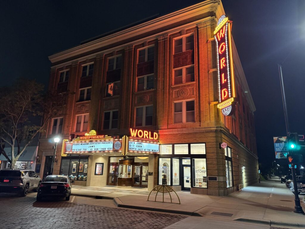 The glowing lights from the World Theater Downtown at night. 