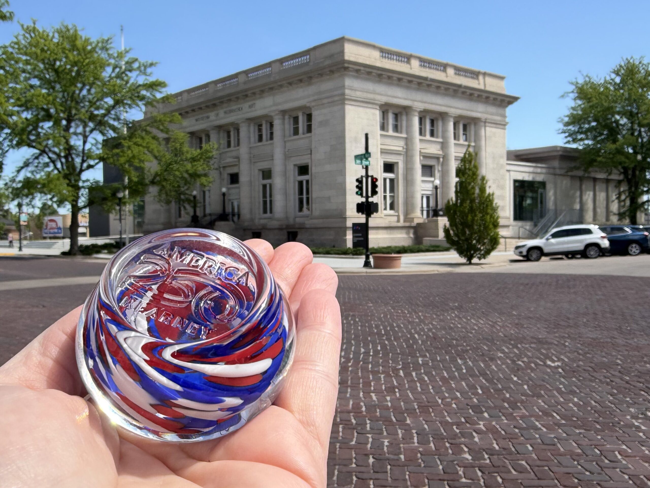 glass paperweight with America 250 stamp